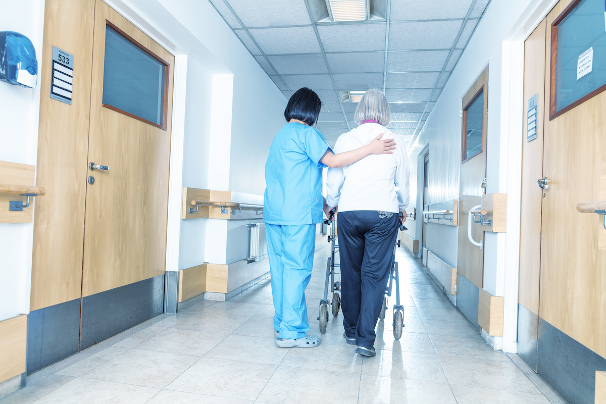 Stroke: A nurse helping elderly woman with a wheelchair,